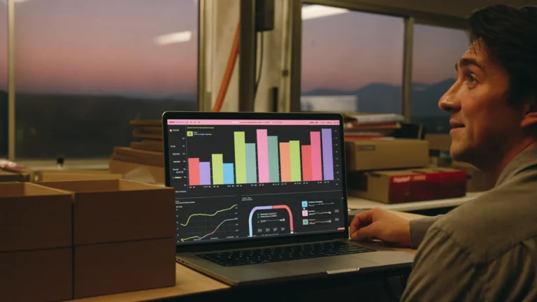 Cardboard box manufacturer reviewing a profitability dashboard on a laptop